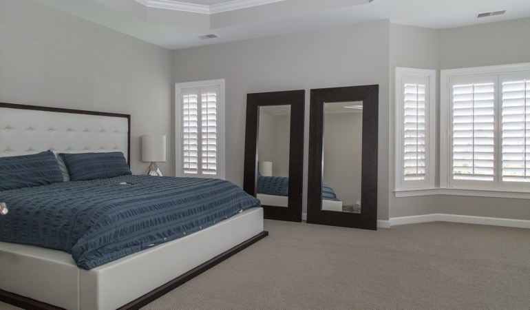 White shutters in a minimalist bedroom in Tampa.